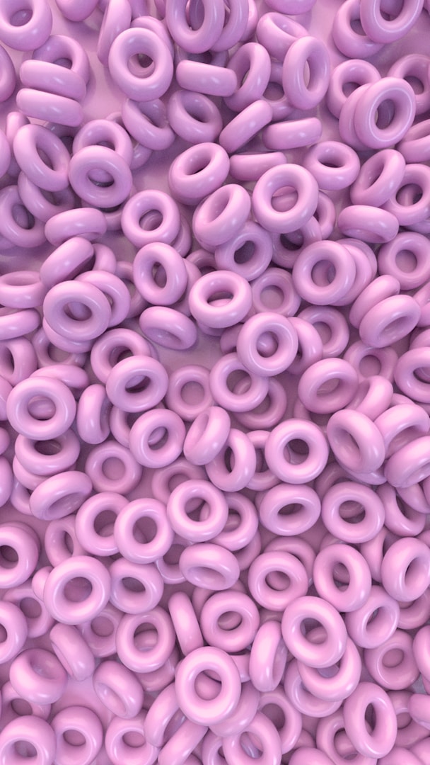 TEST A close-up of small purple cereal rings scattered randomly.